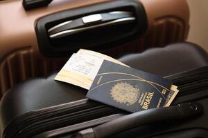 Federative Republic of Brazil passport with tickets lies on touristic suitcase in airport hall photo