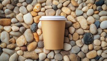 Brown paper cup disposable eco friendly on pebble stones pattern soft color background photo