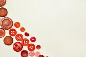 Various buttons of red, ginger, orange colors,place for text photo