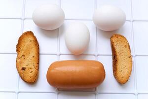 Just delicious breakfast. Sausage, toasted bread, three eggs photo