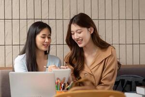 Collaborative Learning and Academic Growth. Two friends sharing notes while brainstorming at a cafe table. photo