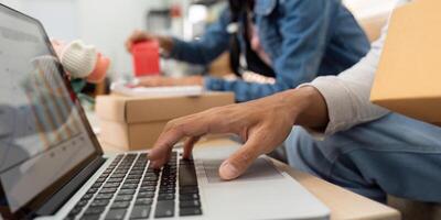 Data Analysis and Strategy. A close-up of hands on a laptop, analyzing business metrics while working with a partner. photo