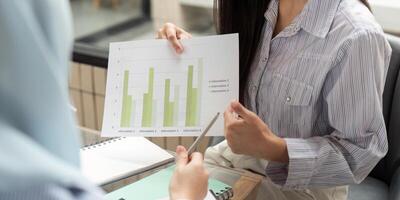 Data Analysis and ESG Strategies. Discussion on sustainable practices with visual data in a corporate setting. photo