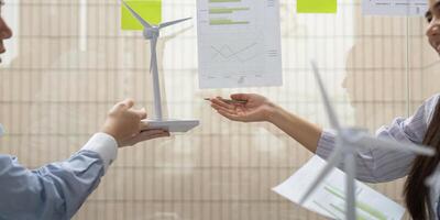 Renewable Energy Collaboration. Professionals discussing wind energy projects and sustainability metrics in a corporate environment. photo