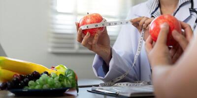 Nutrition and Wellness. A nutritionist measuring apples to explain portion control. photo