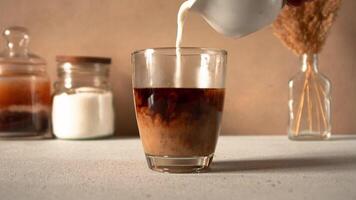 Coffee with milk making process. Stop motion animation horizontal . Coffee appearing in a glass and hand pouring milk into a glass video