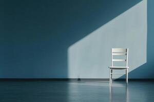 Empty white chair in minimalist room with blue wall and sunlight streaming in photo