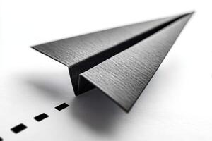 Paper airplane crafted with precision on a clean surface in a well-lit space photo