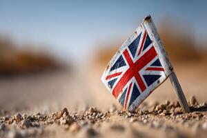 Small British flag mark in a dusty road setting during afternoon sunlight photo