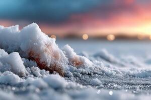 Snow-covered ground with sparkling frost at sunset over a winter landscape photo