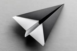 Creative paper airplane design made from black and white materials on a light surface photo