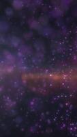 Cosmic background with sparkling purple particles and bokeh lights. Magical and dreamy starfield in deep space video