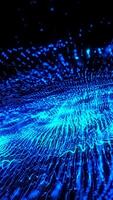 Exploding wave of luminous blue particles in motion a video