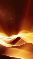 Bright orange abstract wave flowing in soft focus with glowing light streaks on a dark background video