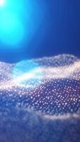 Radiant burst of soft blue light above a shimmering field of glowing particles on a cool gradient background video