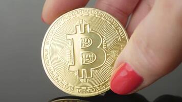 Slow rotation of the bitcoin gold coin in your hand. Electronic cryptocurrency - virtual money, blockchain technology. P2P trading of bitcoin BTC. the payment system. Business mining and investments video