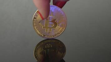 Spin a bitcoin gold coin in your hand. Electronic cryptocurrency - virtual money, blockchain technology. P2P trading of bitcoin BTC. the payment system. Business mining and investments video