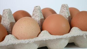 Fresh brown eggs in a cardboard box. Chicken eggs in a package close-up. Farmer's eco-friendly product chicken eggs for sale on the market non-gmo video