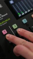 Fingers sliding audio mixer fader in recording studio video