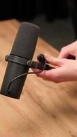 Connecting microphone to cable on wooden table video