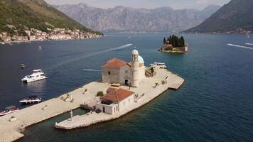 Drone view of Island of Our Lady of the Rocks near the city of Perast in the Bay of Kotor in Montenegro. Aerial view of the island travel destination in the adriatic Sea video