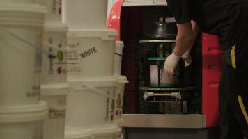 A worker mixes the material for puttying the walls in centrifuge video
