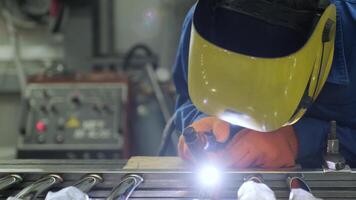 Man wearing mask welding in a workshop. Metal workers use manual labor. Skilled welder. Welder is welding the stainless steel pipes in the factory. welder Industrial part in factory. 16 video