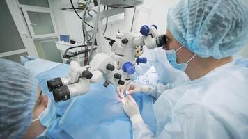 Surgery team making strabismus surgery using modern technologies, latest devices, microscope in modern clinic 9 video