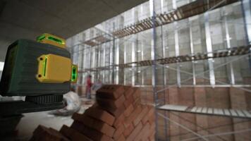 The builder measures the repair lines using a green laser level video