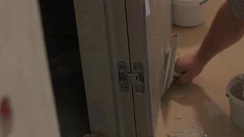Worker applies decorative plaster with a thin spatula. Giving a unique texture to white walls. Venetian plaster 7 video