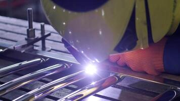 Man wearing mask welding in a workshop. Metal workers use manual labor. Skilled welder. Welder is welding the stainless steel pipes in the factory. welder Industrial part in factory. 15 video