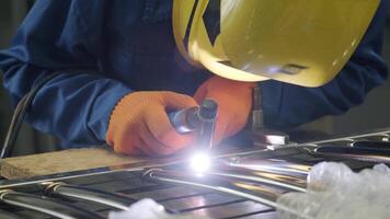 Man wearing mask welding in a workshop. Metal workers use manual labor. Skilled welder. Welder is welding the stainless steel pipes in the factory. welder Industrial part in factory. 17 video