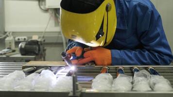 Man wearing mask welding in a workshop. Metal workers use manual labor. Skilled welder. Welder is welding the stainless steel pipes in the factory. welder Industrial part in factory. 18 video
