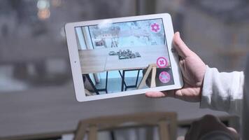 Man Holding Digital Tablet with Augmented Reality Software Chooses 3D buildings. Over Shoulder Screen 2 video