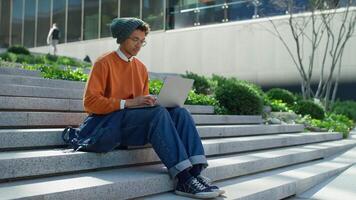 Young man working on laptop outdoors video