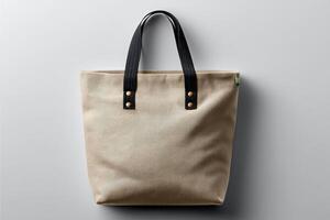 Stylish and functional canvas tote bag with sturdy black handles on a simple gray background photo