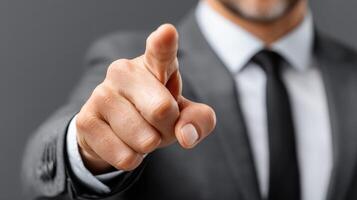Businessman confidently pointing with a serious expression during professional meeting photo