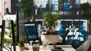 Computer screen on office desk displaying financial charts of company profits performance metrics. Data analytics on PC display showing corporate business earnings KPIs, panning shot video