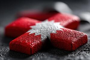 Red and white object with star design on dark background captures vibrant contrast photo
