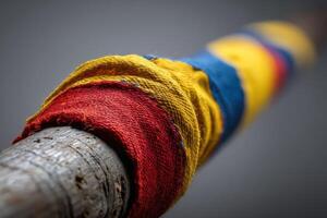 Colorful fabric wrapped around a wooden pole at a community event in an outdoor setting photo
