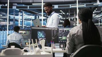 Data center engineer doing node tree programming to optimize resource allocation. Server farm specialist using predictive AI visualization systems for maintenance planning, camera A video