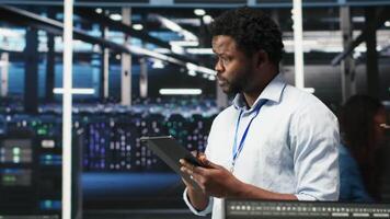 Server farm technician using AI algorithms and node tree systems to categorize unstructured data. Data center worker uses visual programming and natural language processing tools, camera B video
