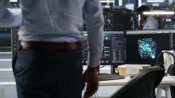 Vertical Server hub programmer using AI machine learning node tree software to optimize system health. Data center IT expert analyzing equipment issues using artificial intelligence visualization, camera B video