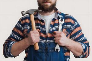 A man with a beard and a tool in his hands photo