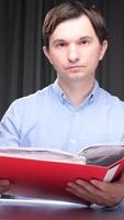 vertical Office worker reading documents in a red folder video