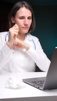 vertical Sick doctor blowing nose at office desk using tissue paper video