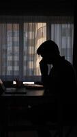 vertical silhouette of a man in the office at his desk suffering from a runny nose video