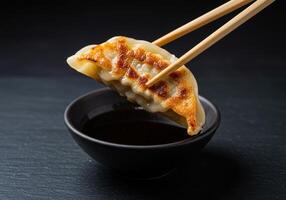 A dumpling with chopsticks in a bowl photo