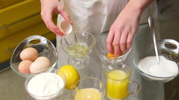 Top view of a table in a bakery, ingredients for dough are placed in glas bowls. flour, eggs, butter and sugar. Dough preparation process. video