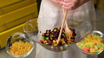 Mixed dried fruit nuts on plate. Dolly zoom in. Colorful assortment of nuts and dried fruits perfect for healthy snacking rotating. Natural food background. Vegan food. Close up in 4K, UHD video